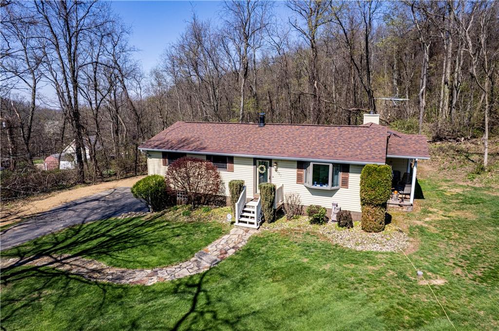 2037 Ridge Road Jeannette, PA 15644 - Photo 24 of 24 a front view of a house with a yard garden and outdoor seating