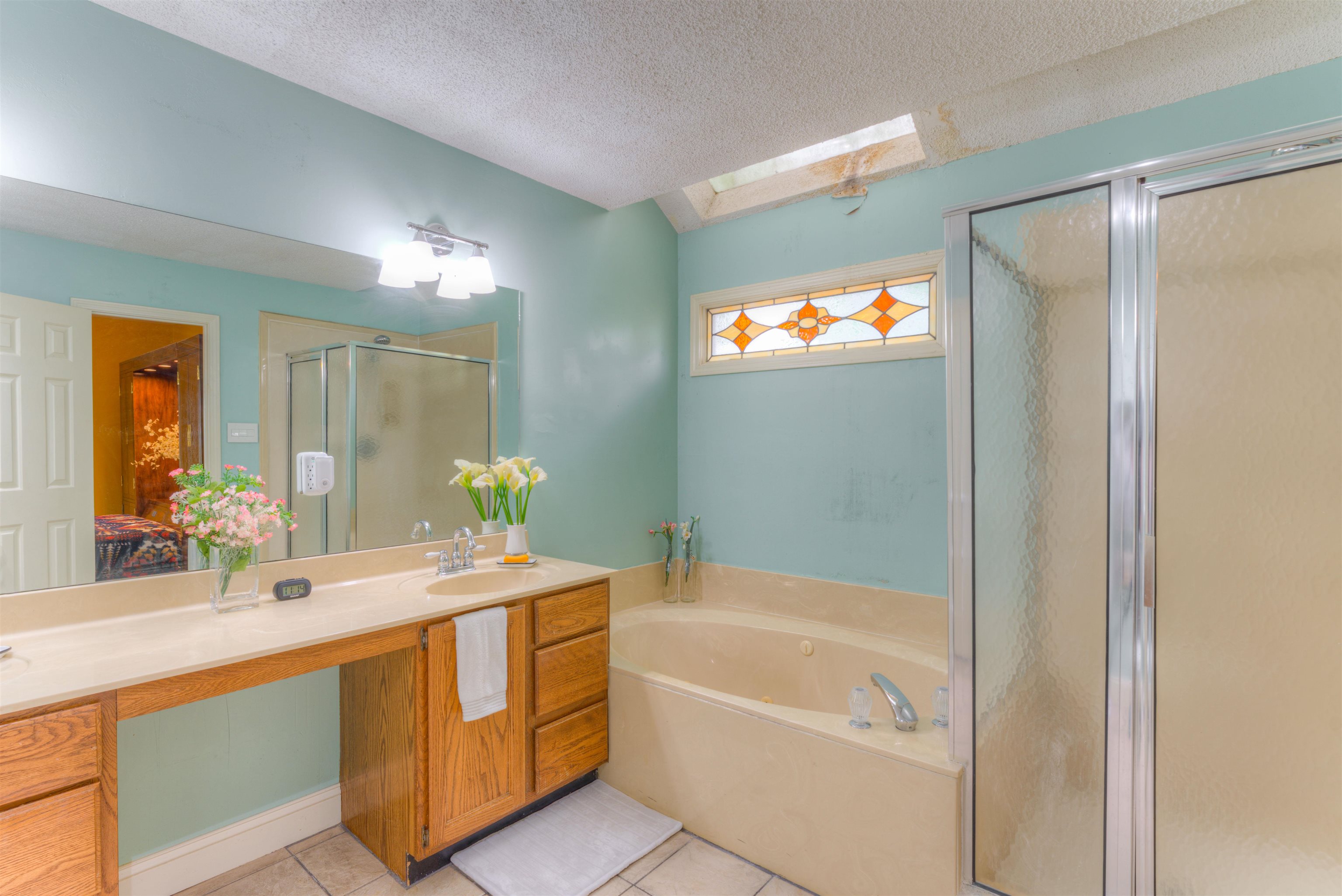 3930 Bobby Jones Road Memphis, TN 38125 - Photo 18 of 35 a bathroom with a tub a sink and mirror