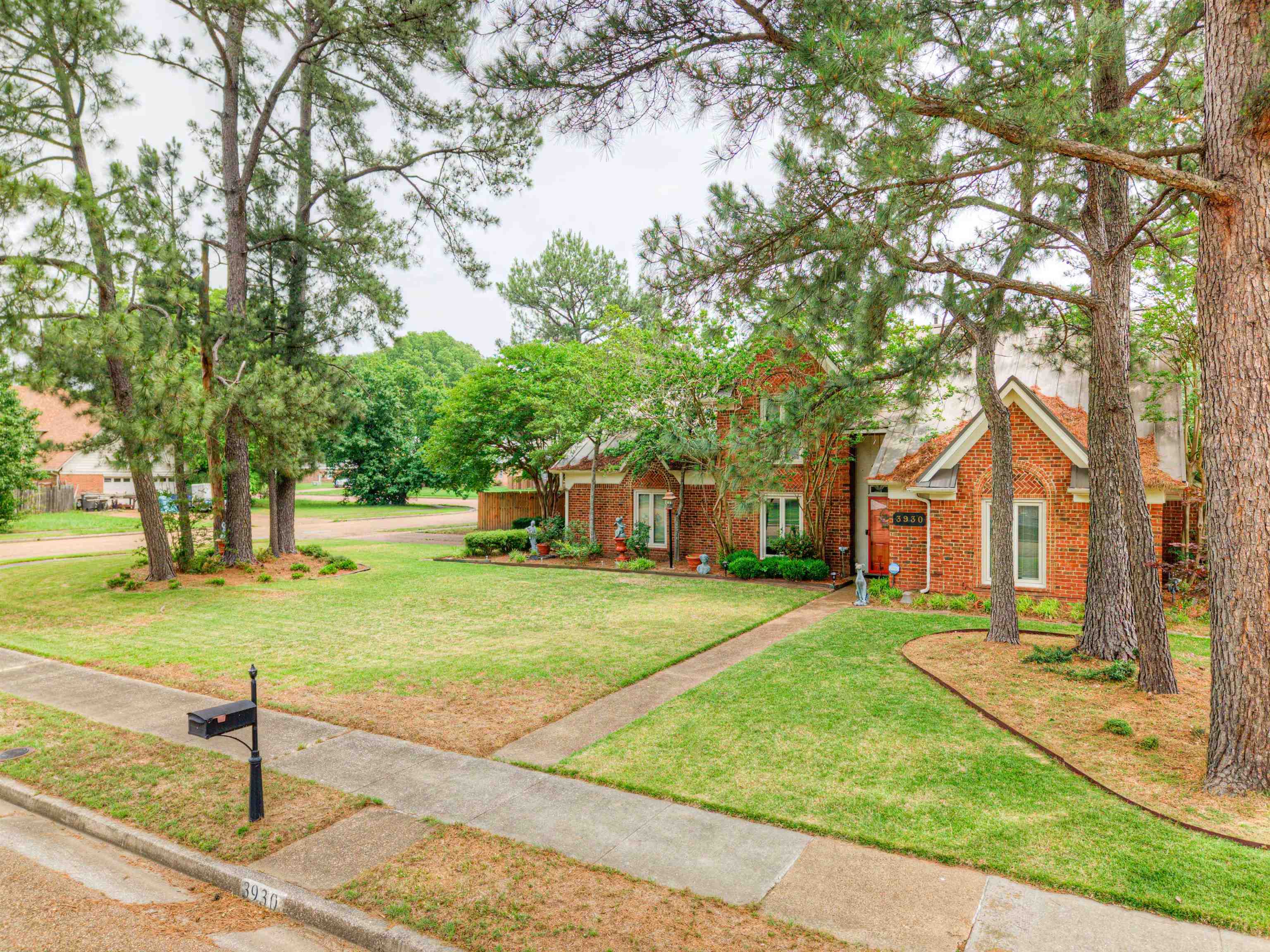 3930 Bobby Jones Road Memphis, TN 38125 - Photo 2 of 35 a front view of a house with a yard and trees