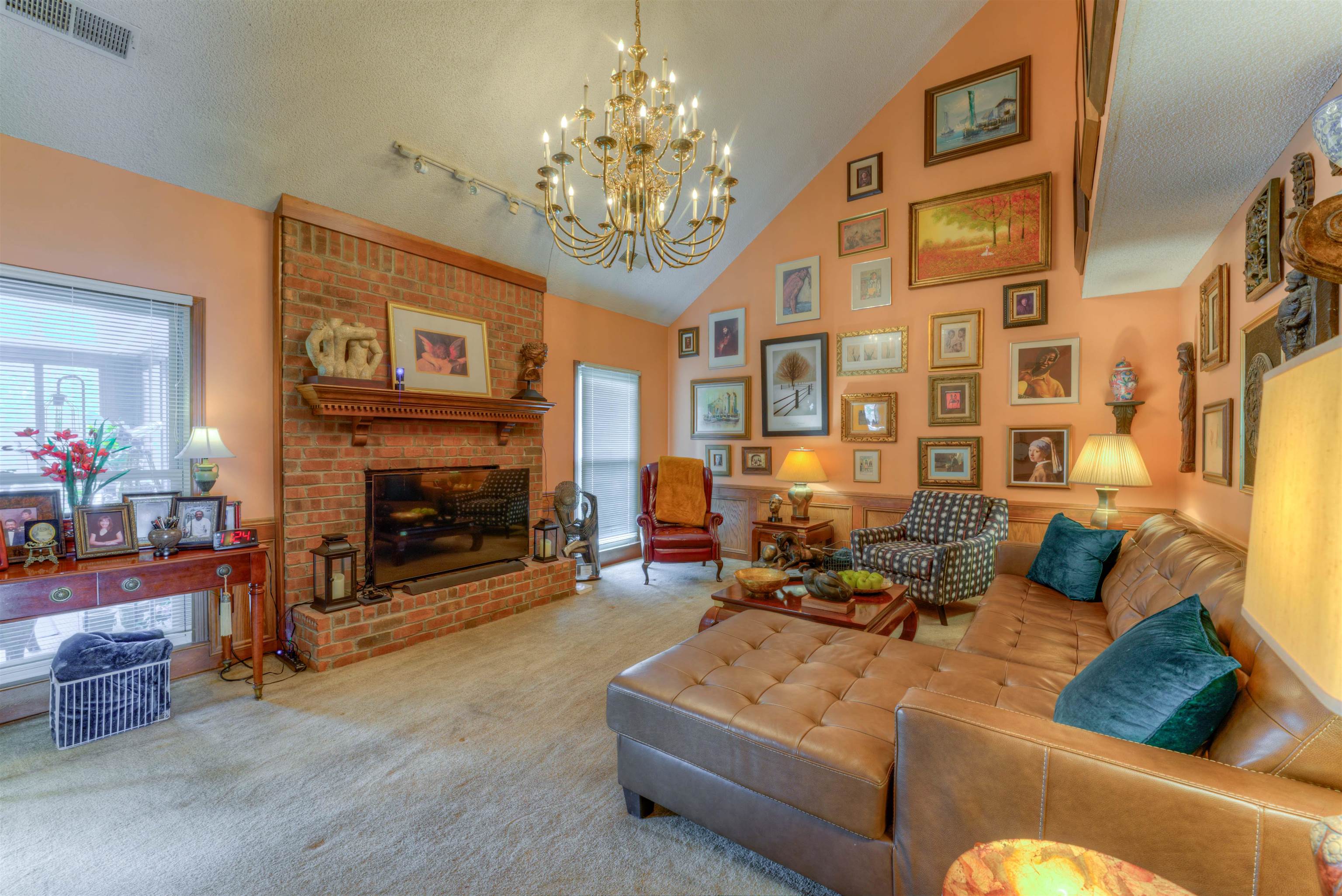 3930 Bobby Jones Road Memphis, TN 38125 - Photo 3 of 35 a living room with furniture a fireplace and a chandelier