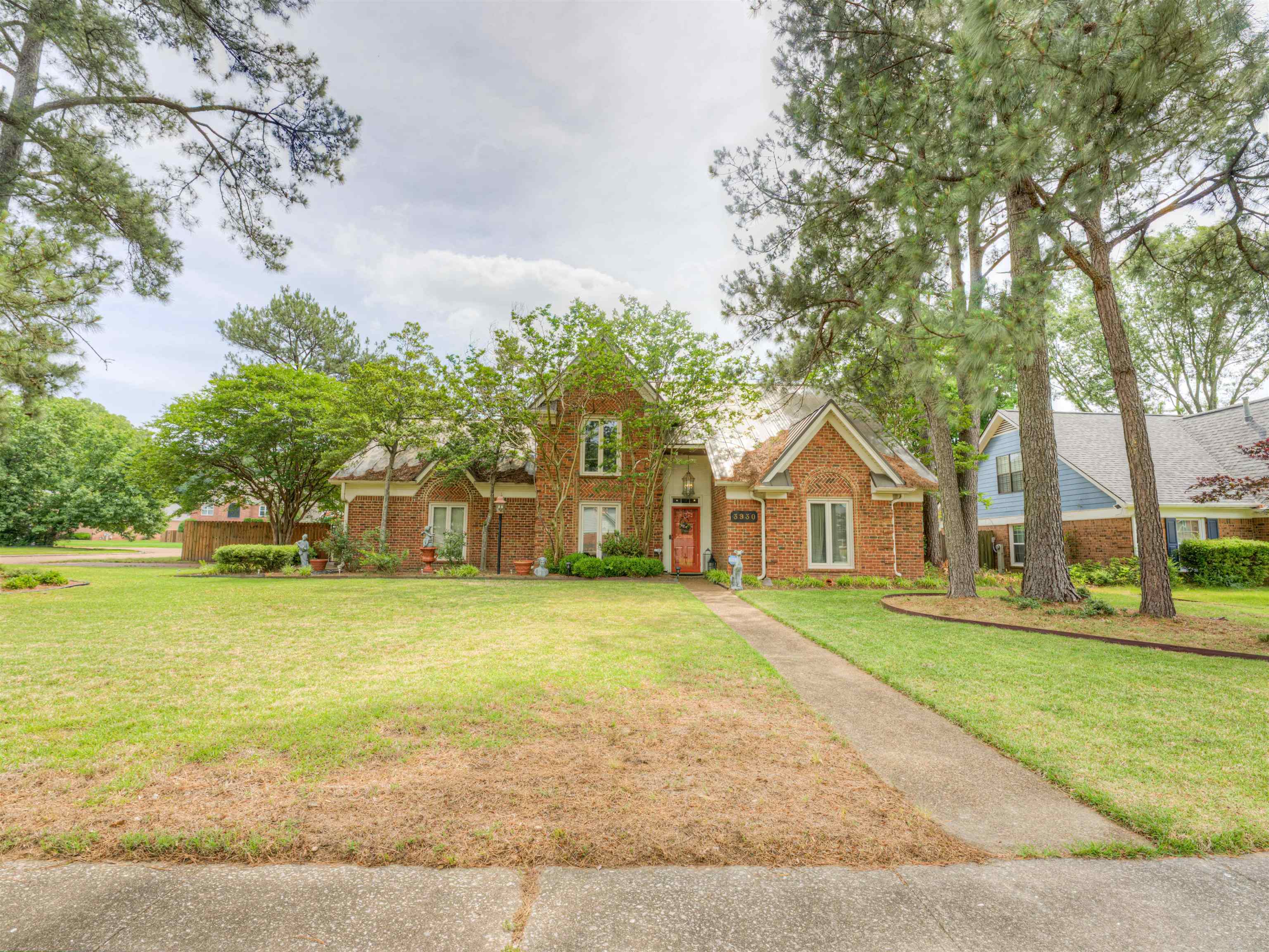 3930 Bobby Jones Road Memphis, TN 38125 - Photo 31 of 35 a front view of a house with a garden and trees