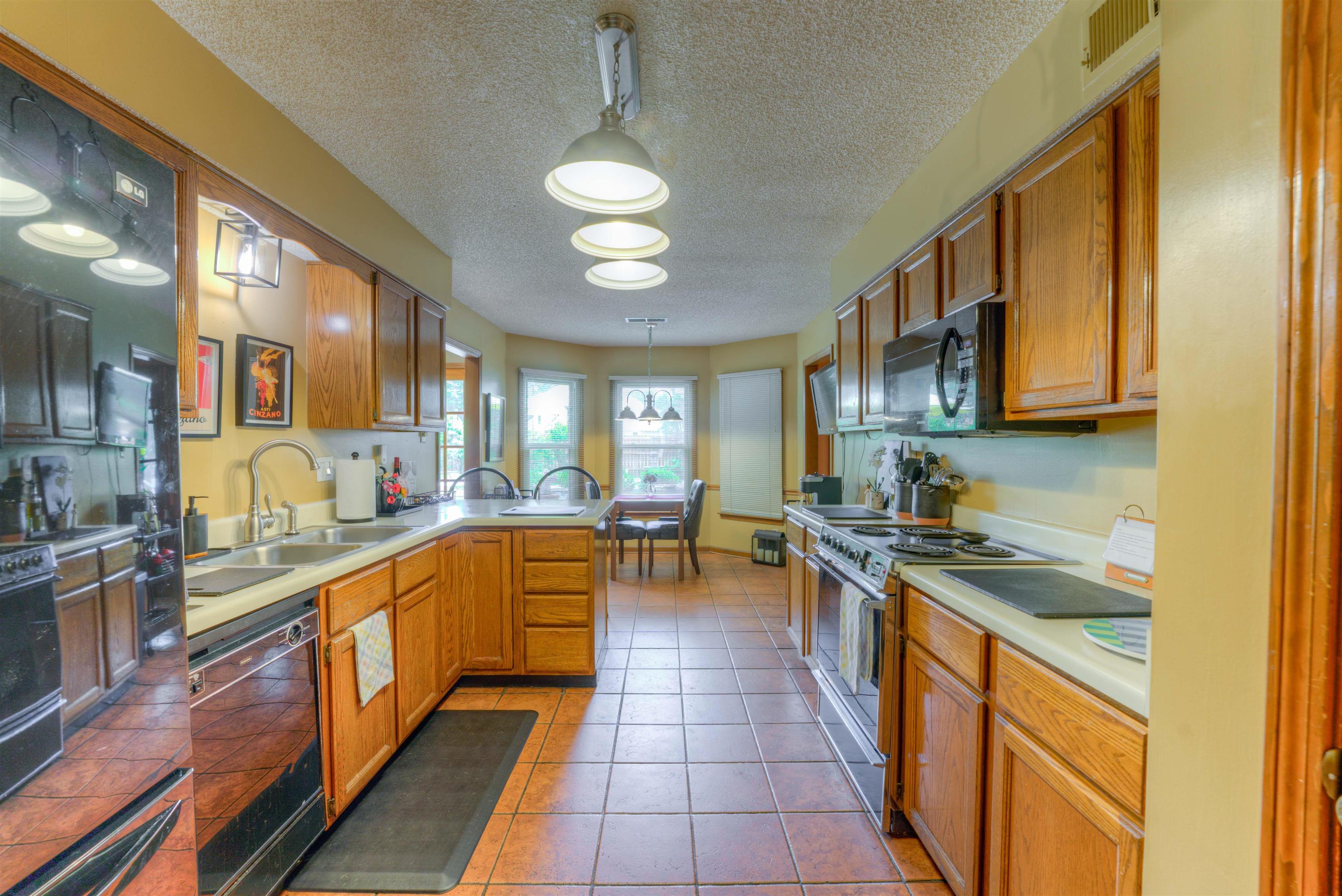 3930 Bobby Jones Road Memphis, TN 38125 - Photo 5 of 35 a large kitchen with stainless steel appliances granite countertop a lot of counter space and a sink