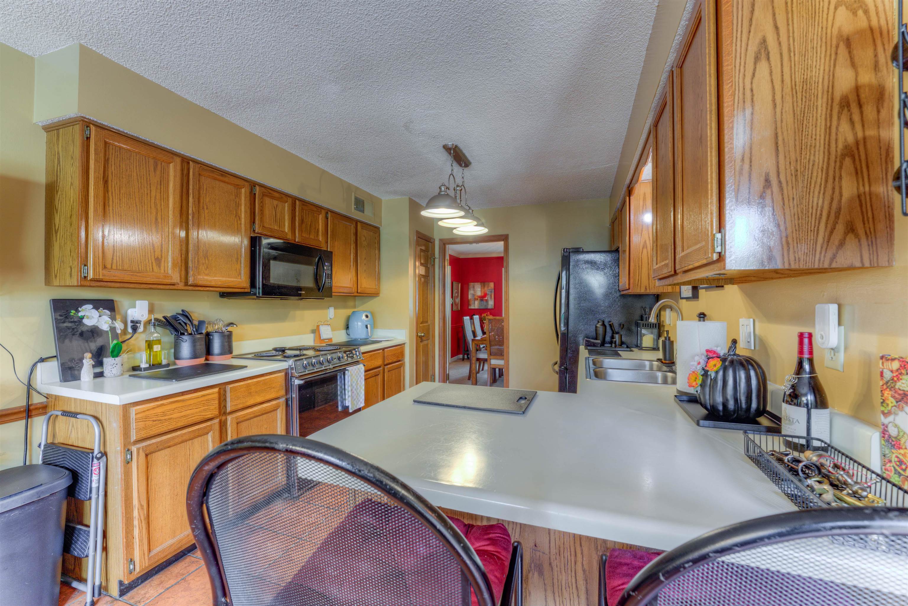 3930 Bobby Jones Road Memphis, TN 38125 - Photo 6 of 35 a kitchen with stainless steel appliances granite countertop a sink a stove top oven a chimney and cabinets