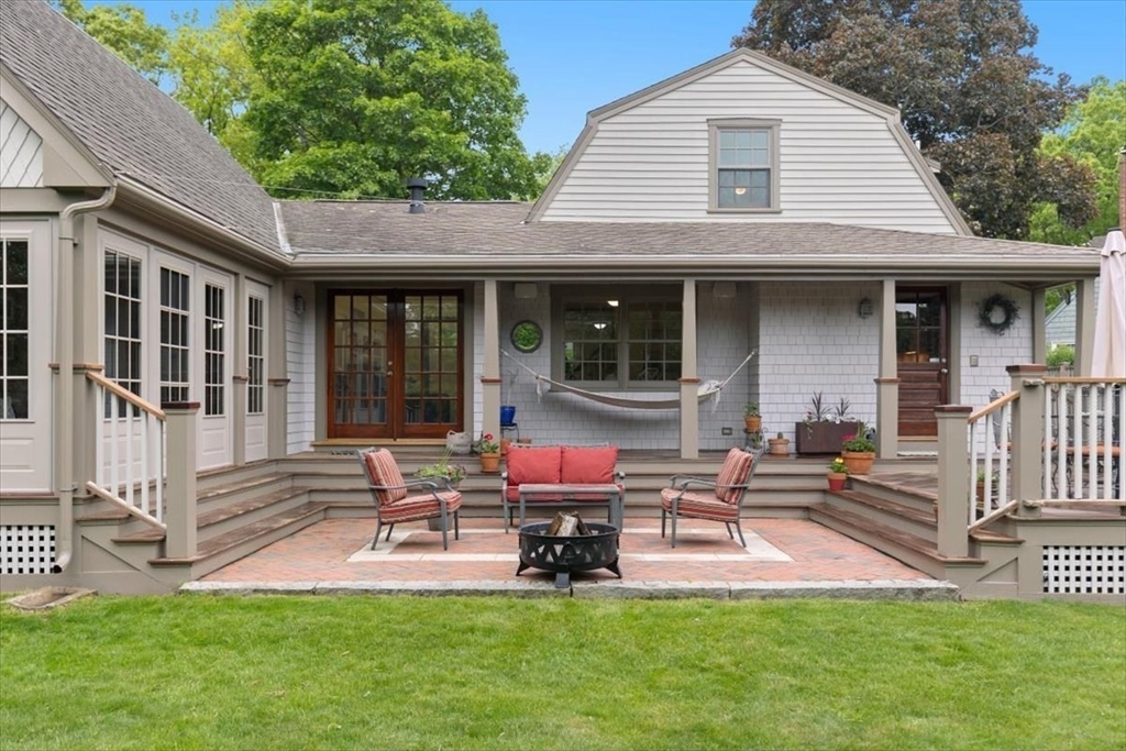 15 Hawthorne Road Hingham, MA 02043 - Photo 29 of 35 a front view of a house with a yard glass top table and chairs