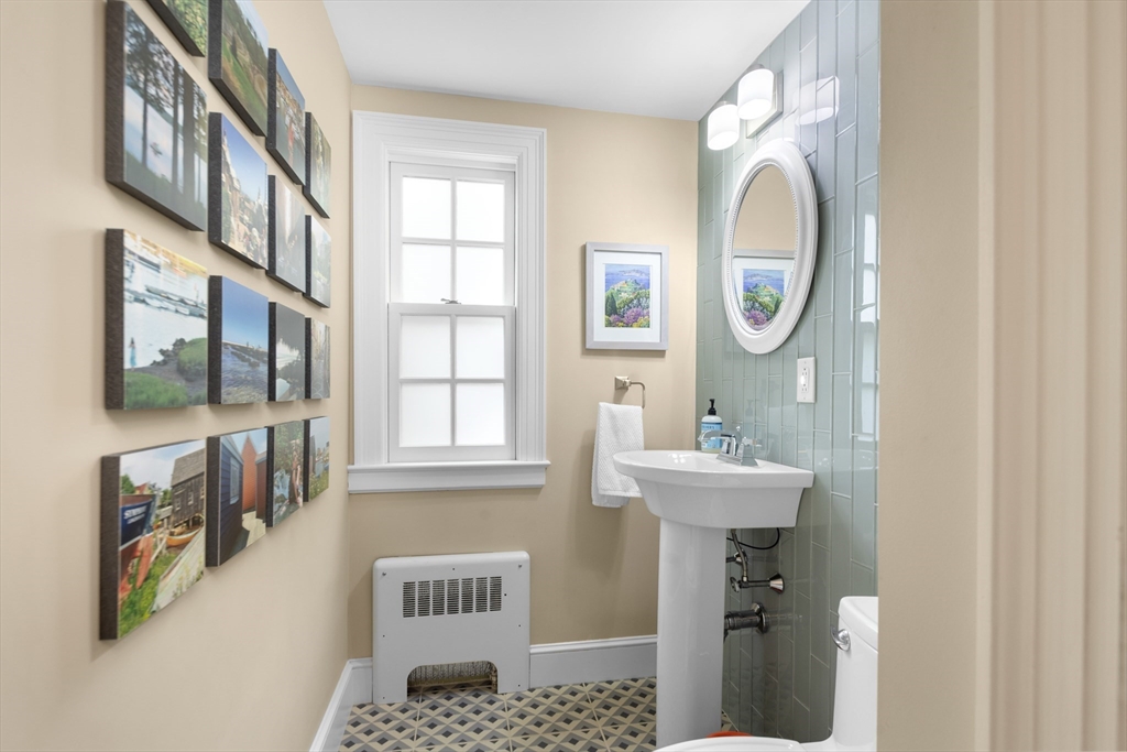 15 Hawthorne Road Hingham, MA 02043 - Photo 6 of 35 a bathroom with a sink a mirror and a window