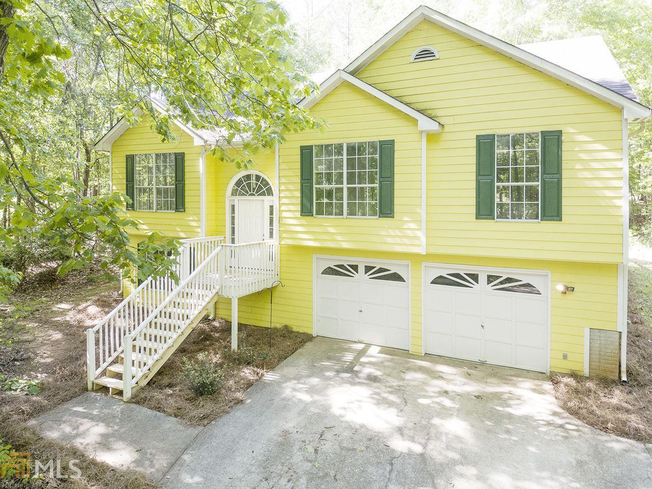 197 Duncans Mill Road Locust Grove, GA 30248 - Photo 1 of 1 a front view of a house with a yard and garage