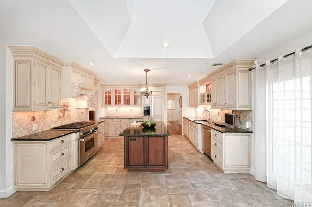 a kitchen with stainless steel appliances kitchen island granite countertop a sink and cabinets