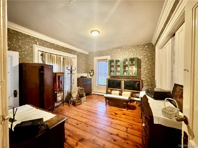 a bedroom with furniture and a large window