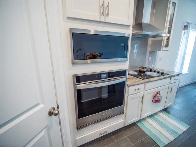 a kitchen with stove and cabinets