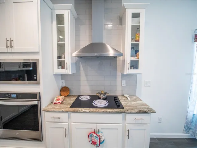 a kitchen with a stove and cabinets