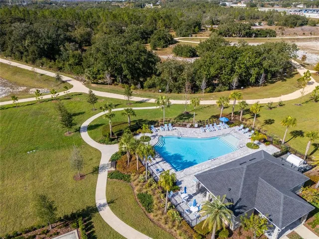 an aerial view of a house with a yard basket ball court and outdoor seating