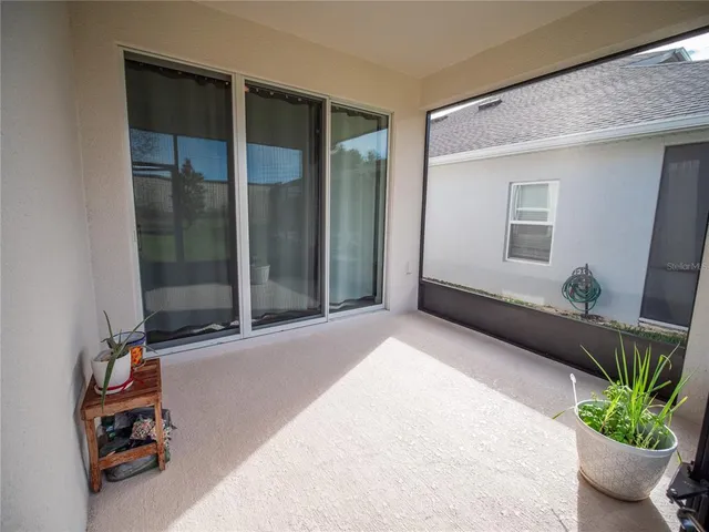 a view of room with window and flower pot