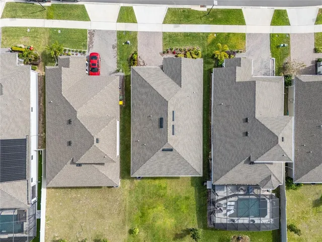 an aerial view of a house with pool