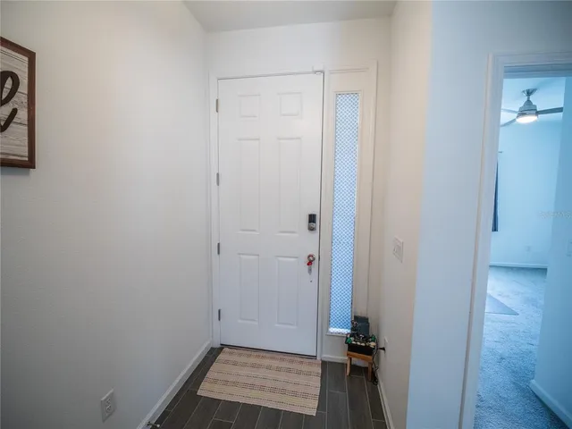 a view of room with walk in closet and wooden floor