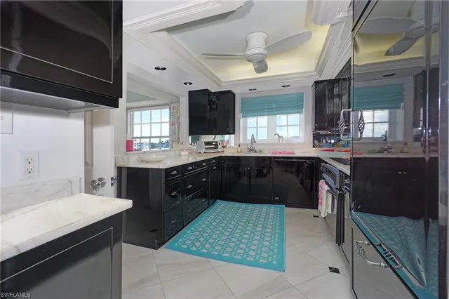 a large kitchen with a stove a sink dishwasher and a refrigerator