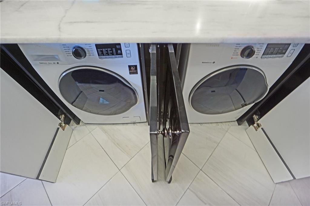 1900 Gulf Shore Boulevard North, Unit 602 Naples, FL 34102 - Photo 19 of 35 a utility room with dryer and washer