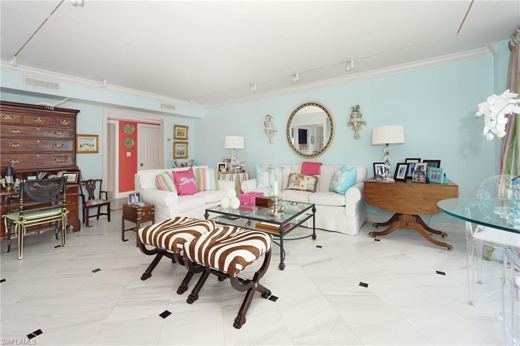 1900 Gulf Shore Boulevard North, Unit 602 Naples, FL 34102 - Photo 6 of 35 a living room with furniture and a clock