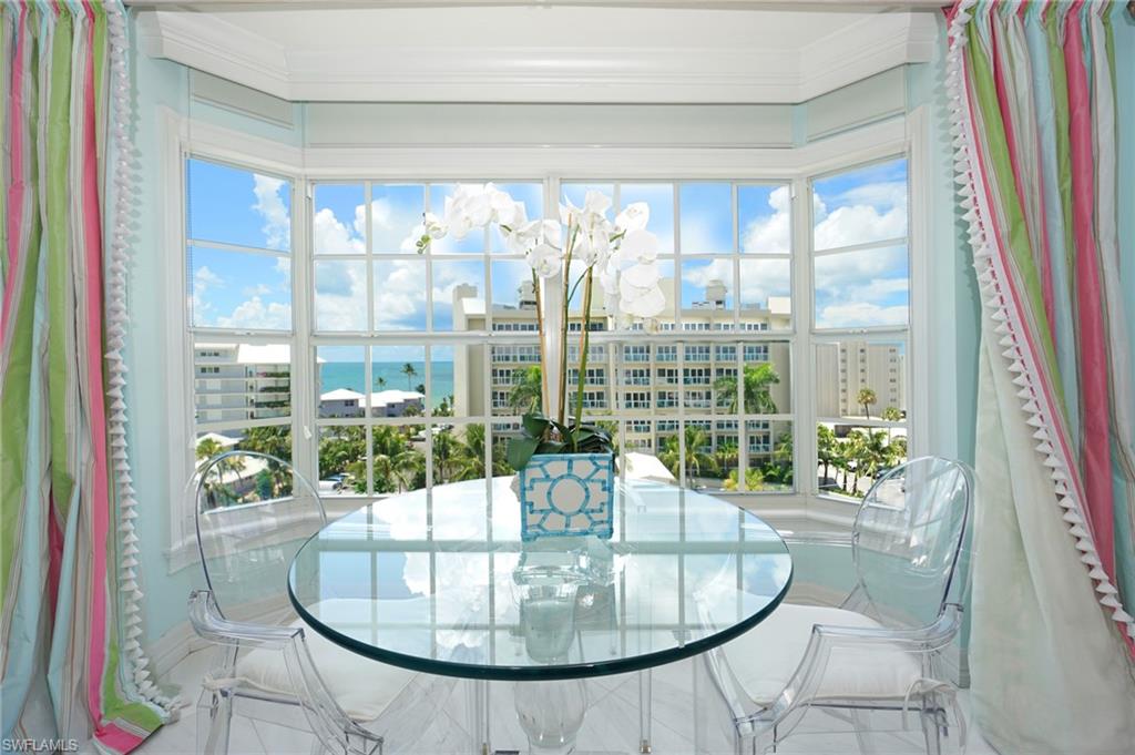 1900 Gulf Shore Boulevard North, Unit 602 Naples, FL 34102 - Photo 9 of 35 a dining room with furniture and wooden floor
