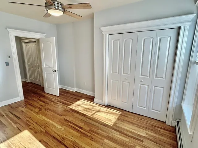 a view of a livingroom with wooden floor and closet area