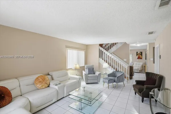 a living room with furniture and a potted plant