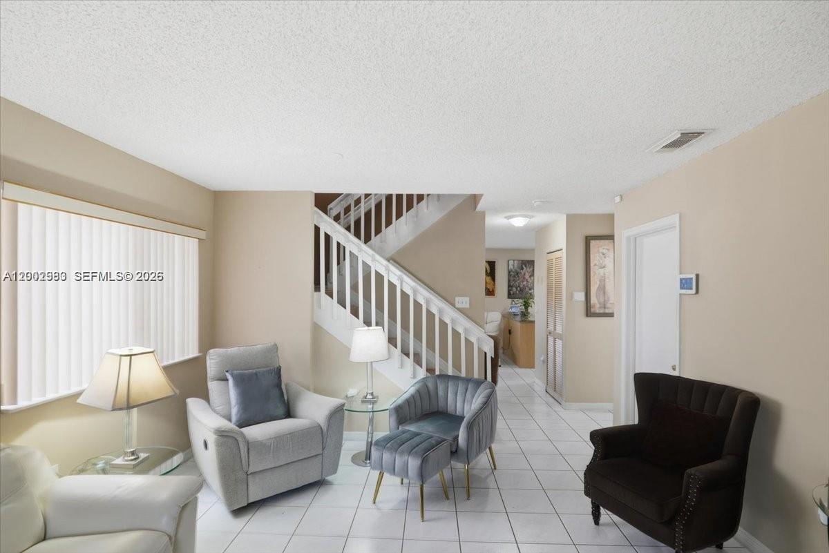 13741 Southwest 160th Terrace Miami, FL 33177 - Photo 15 of 34 a living room with furniture and a potted plant