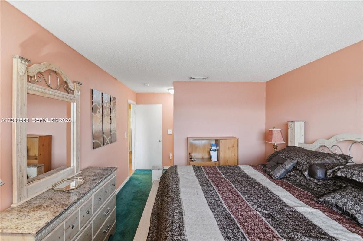 13741 Southwest 160th Terrace Miami, FL 33177 - Photo 21 of 34 a bedroom with a bed and a dresser