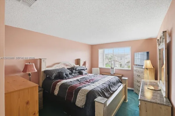 a bedroom with a bed and a television