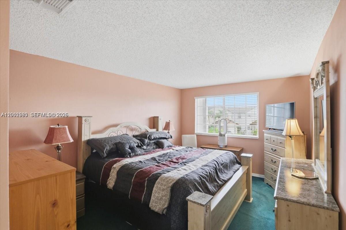 13741 Southwest 160th Terrace Miami, FL 33177 - Photo 23 of 34 a bedroom with a bed and a large window