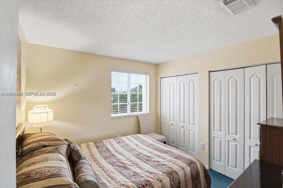 13741 Southwest 160th Terrace Miami, FL 33177 - Photo 24 of 34 a bedroom with a bed and a window