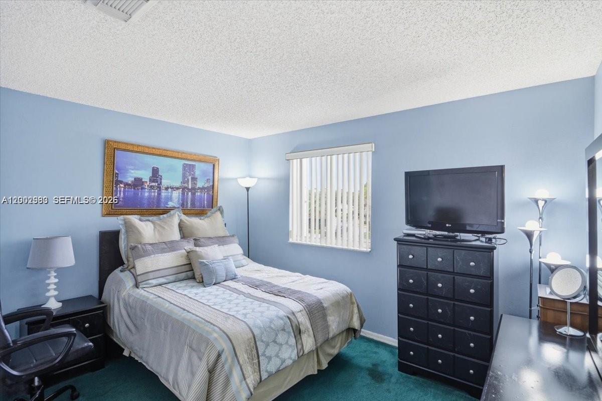 13741 Southwest 160th Terrace Miami, FL 33177 - Photo 25 of 34 a bedroom with a bed and a television