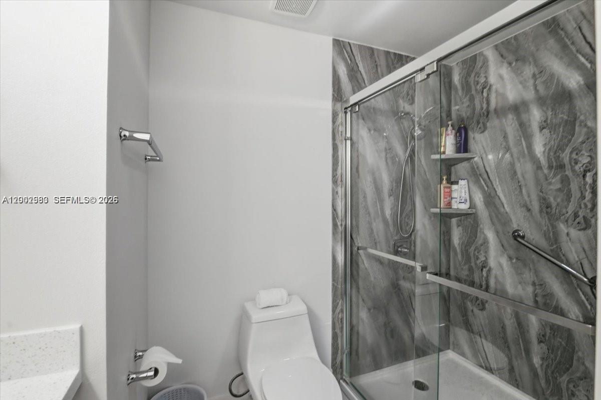 13741 Southwest 160th Terrace Miami, FL 33177 - Photo 27 of 34 a bathroom with a shower and toilet