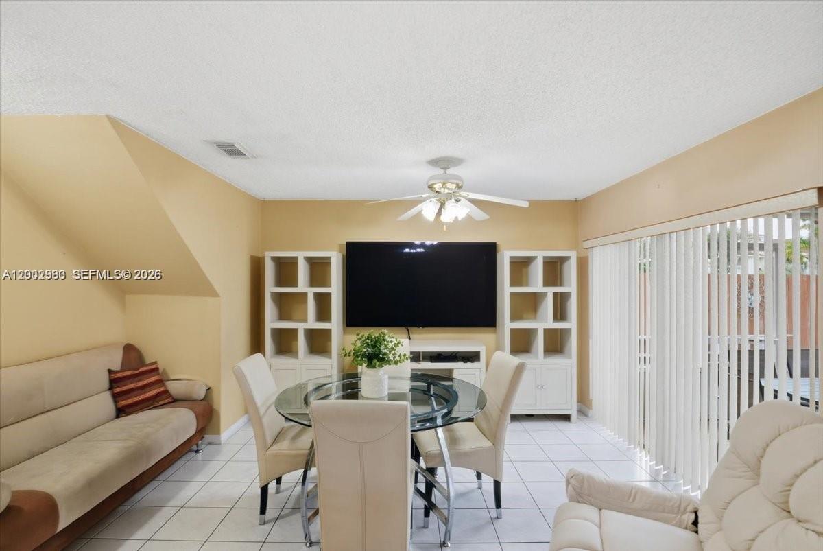 13741 Southwest 160th Terrace Miami, FL 33177 - Photo 4 of 34 a view of a livingroom with furniture and a flat screen tv