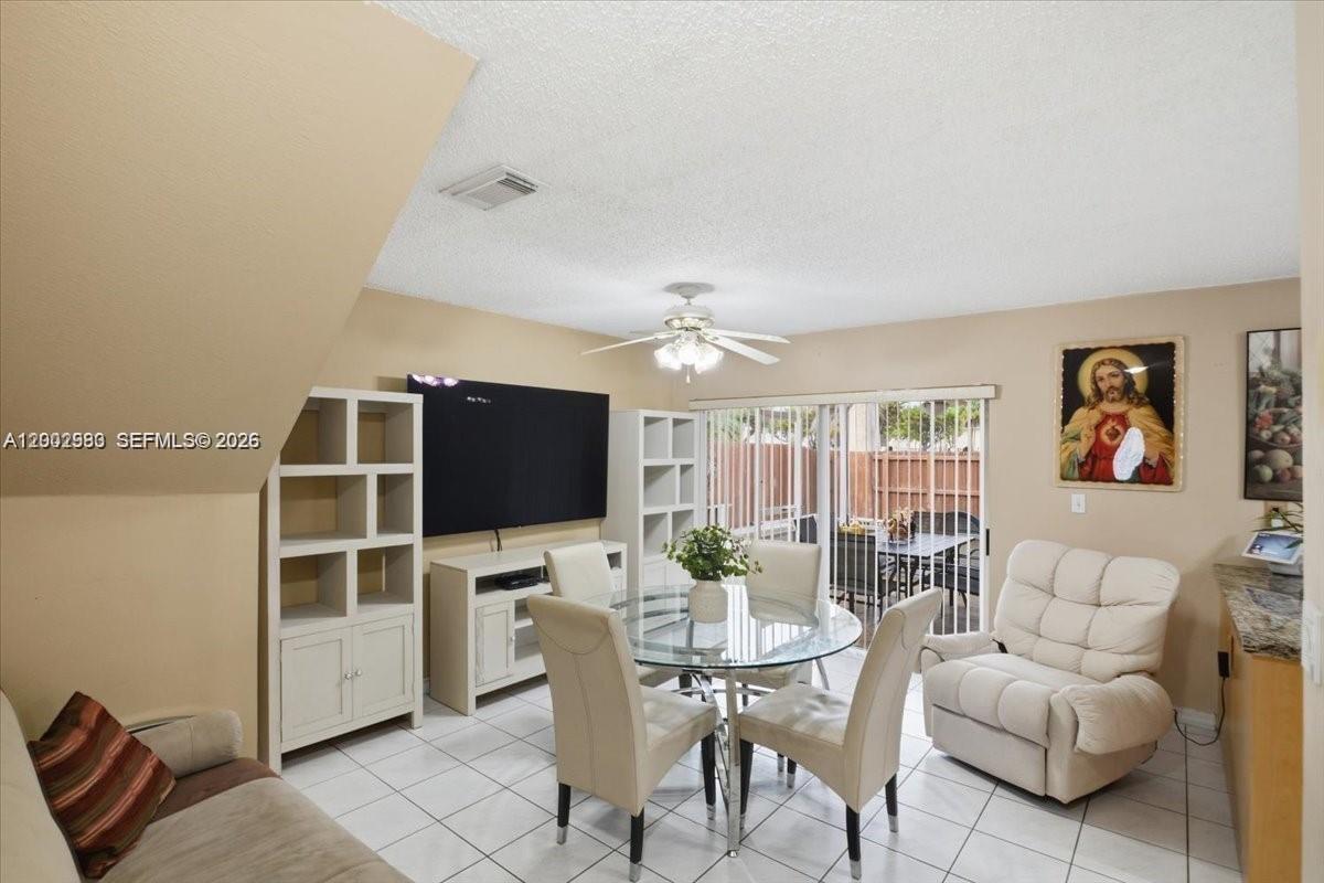 13741 Southwest 160th Terrace Miami, FL 33177 - Photo 5 of 34 a living room with furniture a flat screen tv and a large window