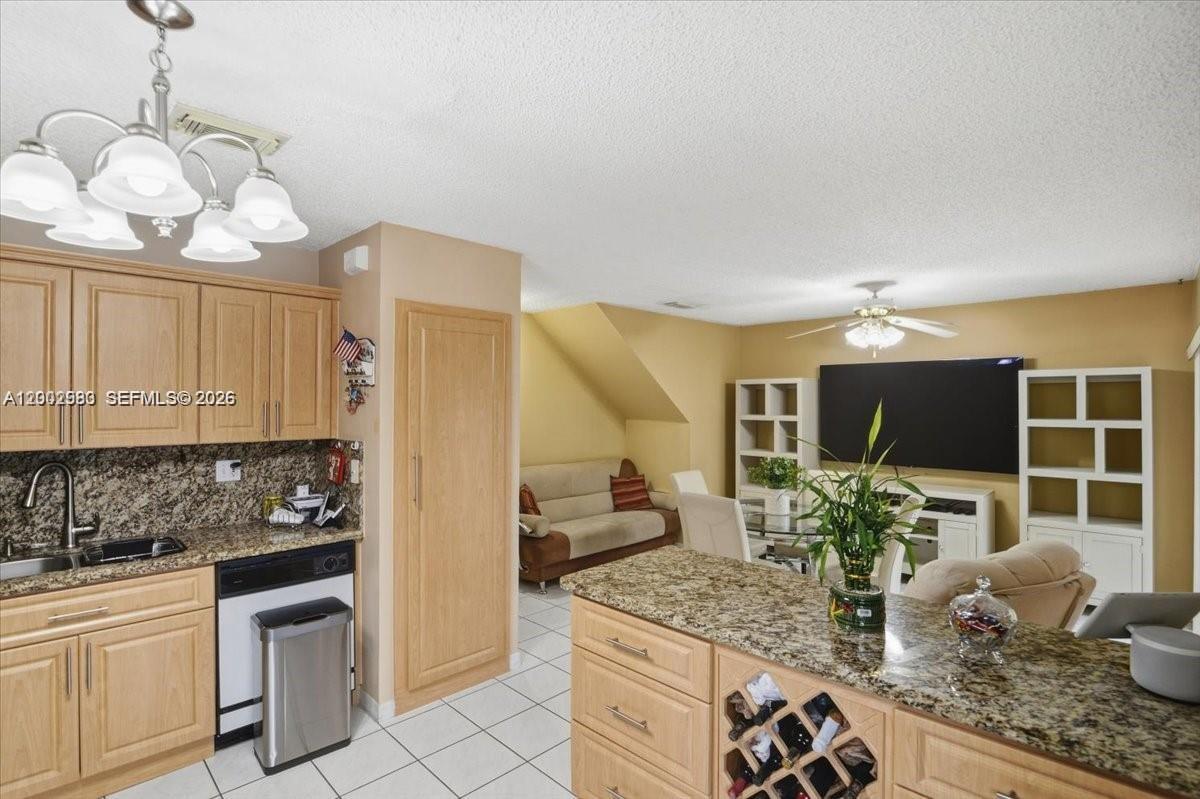 13741 Southwest 160th Terrace Miami, FL 33177 - Photo 6 of 34 a kitchen with stainless steel appliances granite countertop a sink and a white cabinets