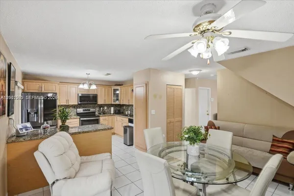 a living room with stainless steel appliances kitchen island granite countertop furniture and a kitchen view