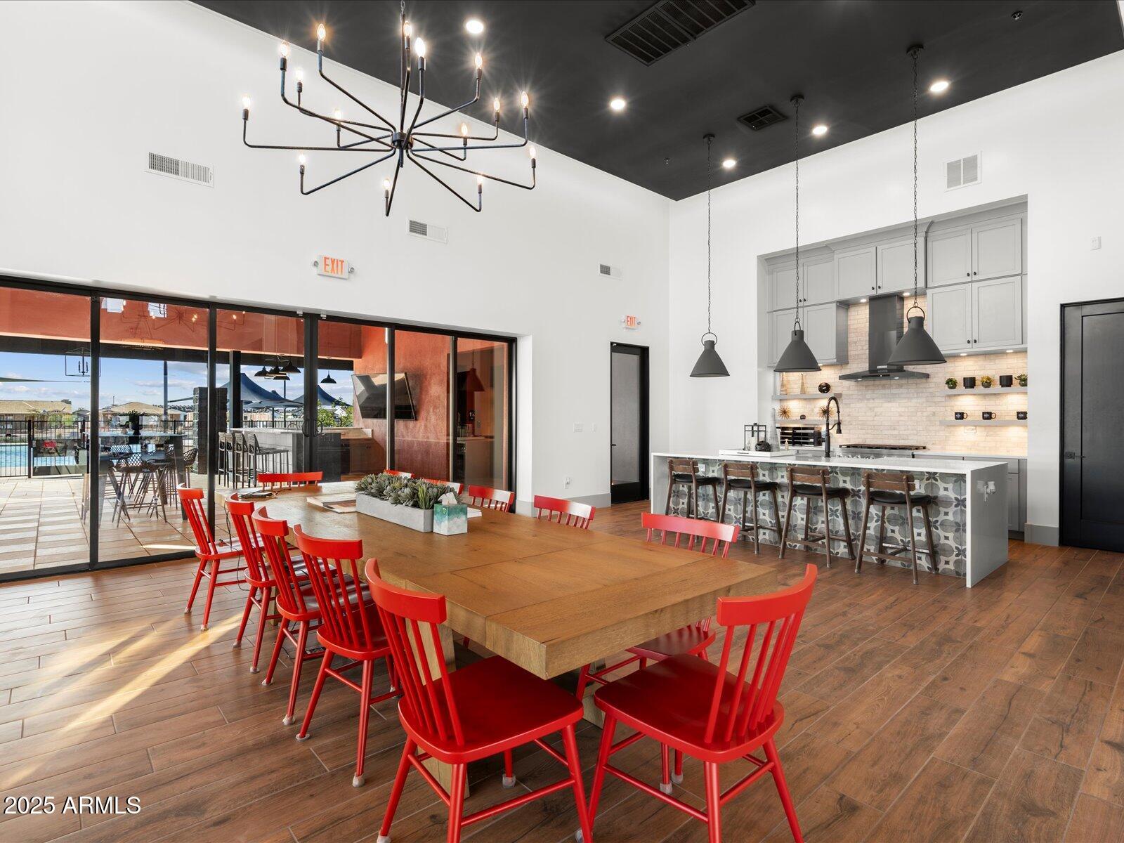 17586 West Monroe Street Goodyear, AZ 85338 - Photo 19 of 23 a view of a dining room with furniture wooden floor and chandelier
