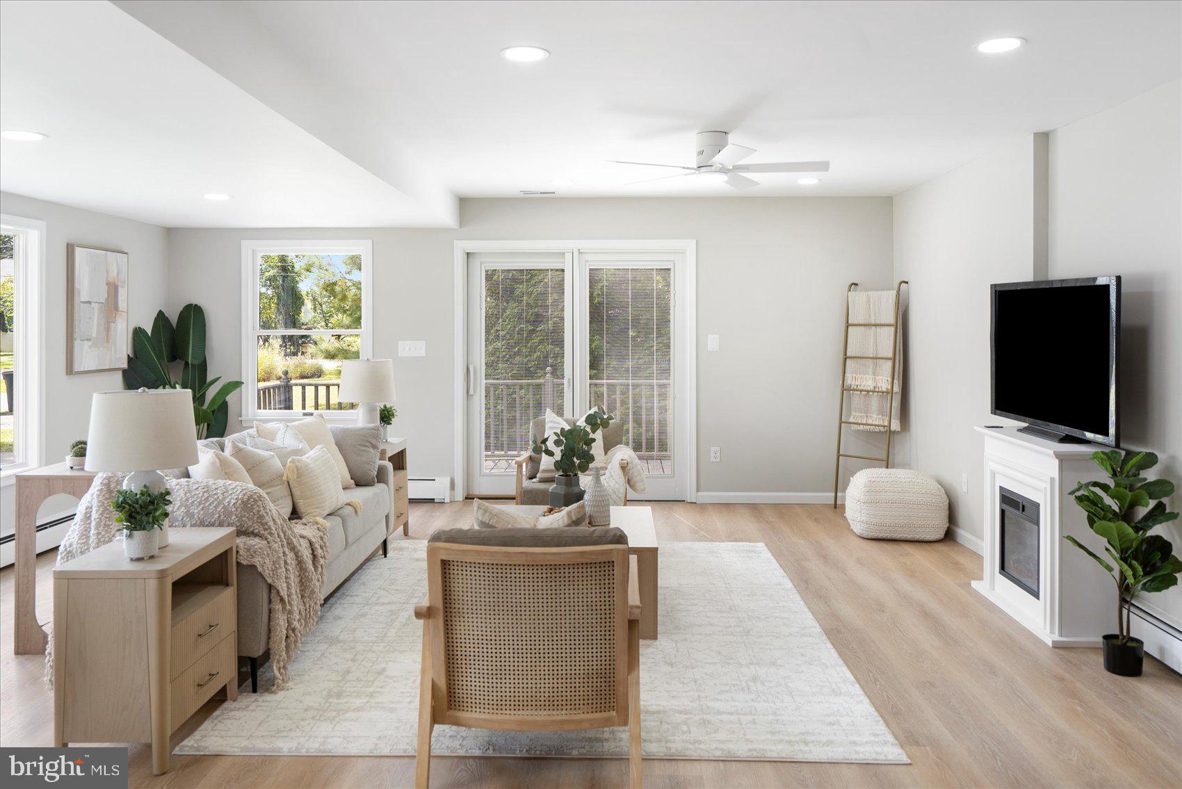 222 Magothy Road Pasadena, MD 21122 - Photo 11 of 30 a living room with furniture a flat screen tv and a large window
