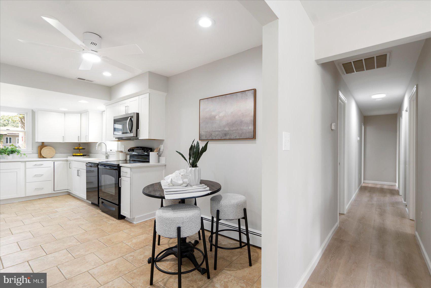 222 Magothy Road Pasadena, MD 21122 - Photo 14 of 30 a kitchen with white cabinets and stainless steel appliances