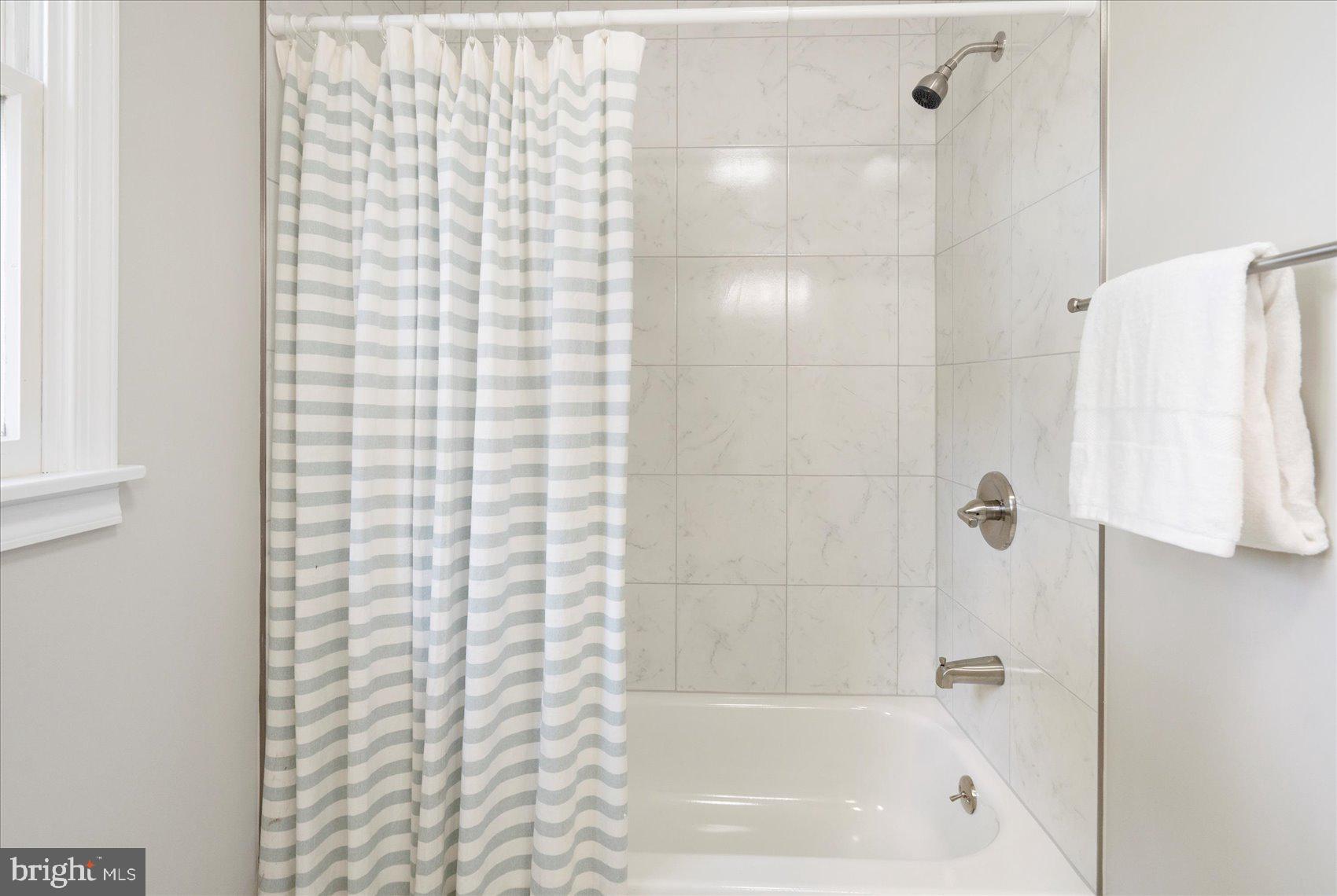 222 Magothy Road Pasadena, MD 21122 - Photo 27 of 30 a bathroom with a shower curtain and a bath tub