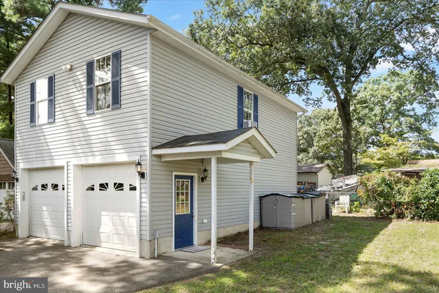 a view of a house with a yard and garage