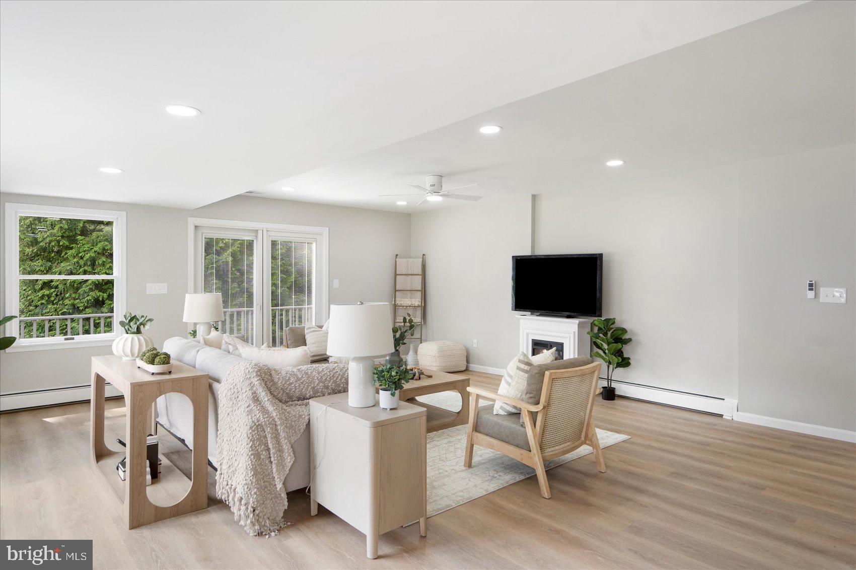 222 Magothy Road Pasadena, MD 21122 - Photo 9 of 30 a living room with furniture a flat screen tv and a large window