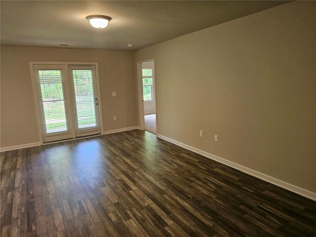 29 Danette Court Dallas, GA 30132 - Photo 5 of 14 an empty room with wooden floor and windows