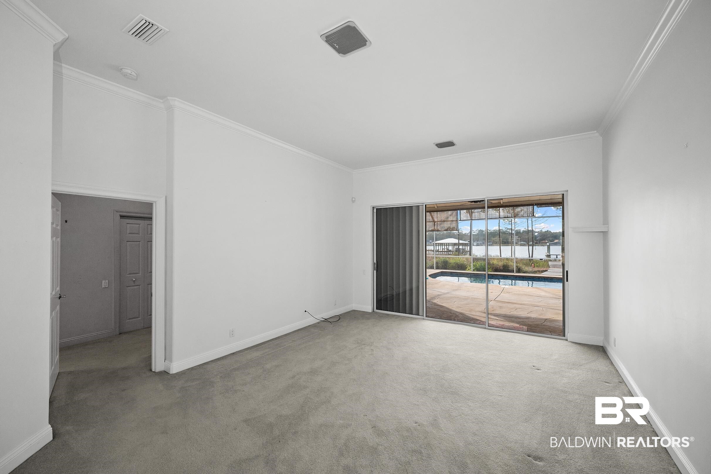 8591 Bay Harbor Road Elberta, AL 36530 - Photo 28 of 56 Carpeted spare room with crown molding
