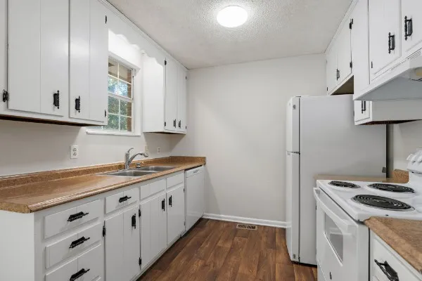a kitchen with a stove and a refrigerator