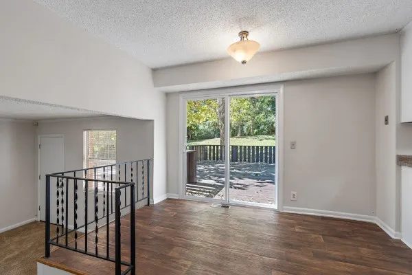 a view of a room with wooden floor and balcony