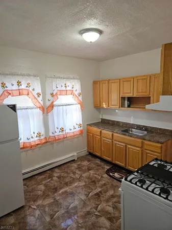 a kitchen with stainless steel appliances a stove and a refrigerator