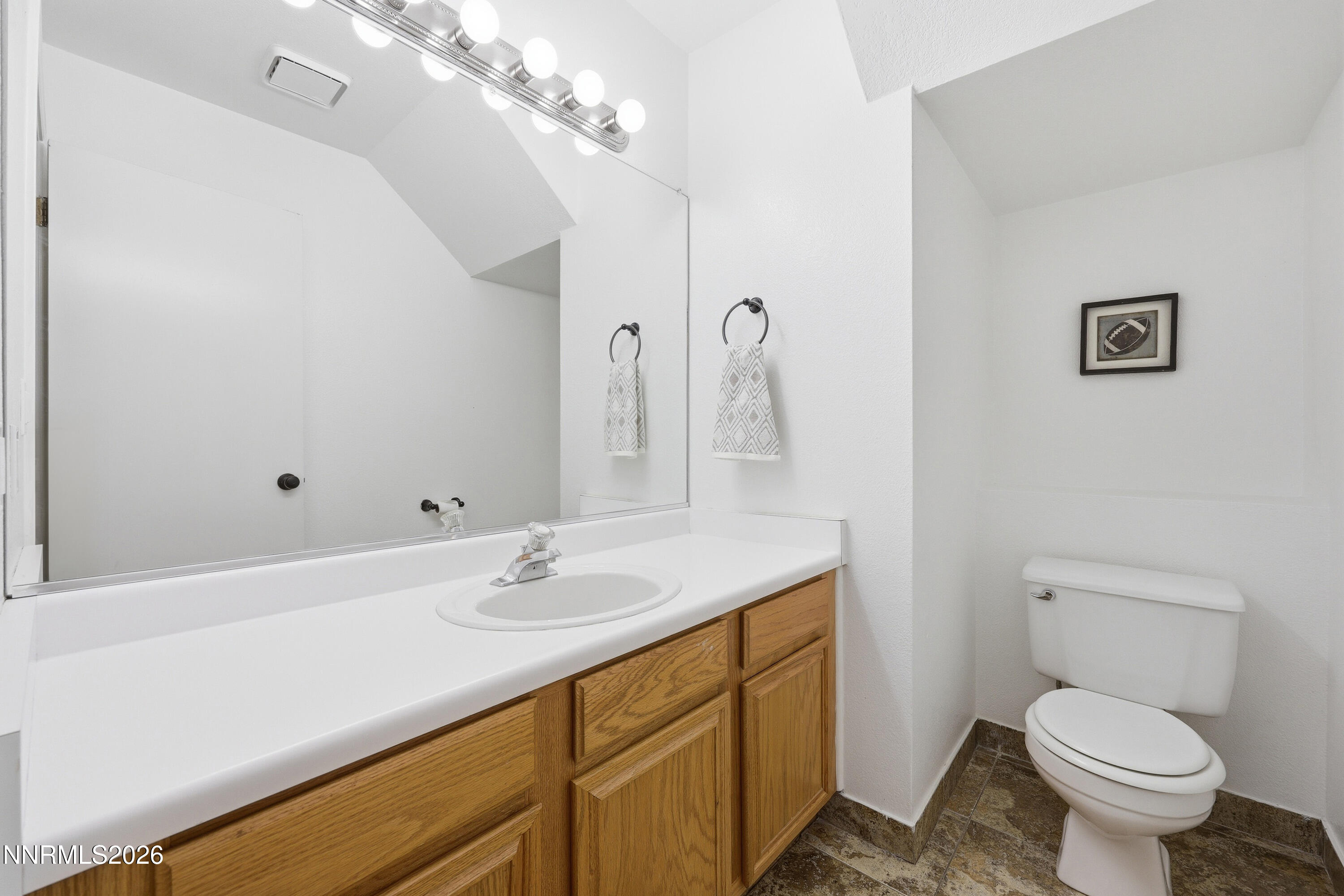 1899 Tuolumne Drive Reno, NV 89523 - Photo 18 of 44 a bathroom with a sink a toilet and a mirror