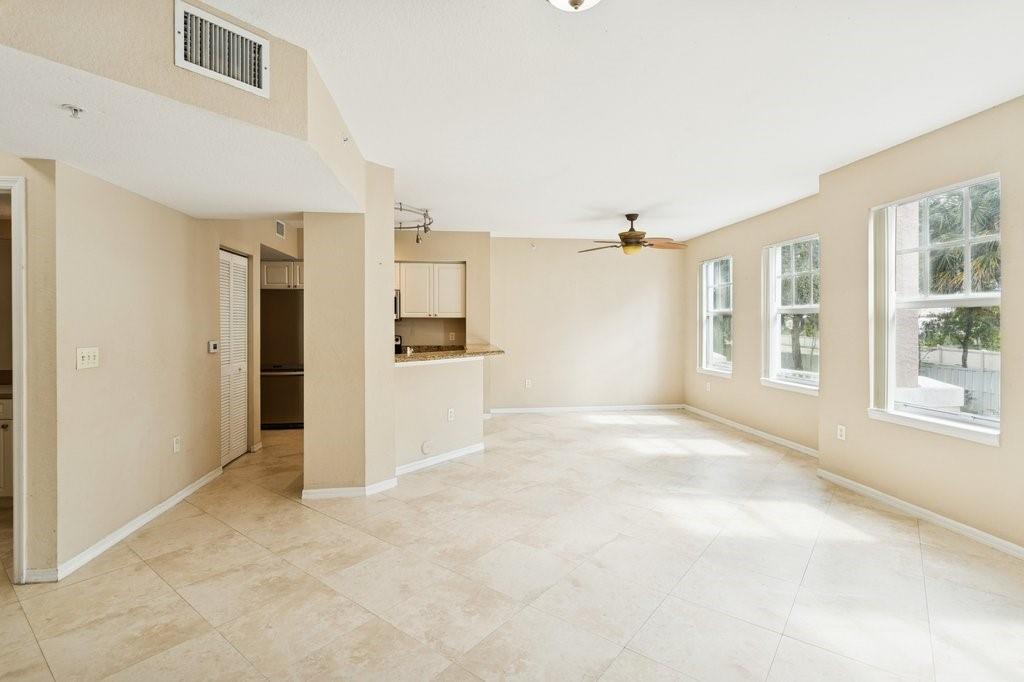 6384 West Sample Road, Unit 6384 Coral Springs, FL 33067 - Photo 5 of 8 a view of a big room with windows and refrigerator