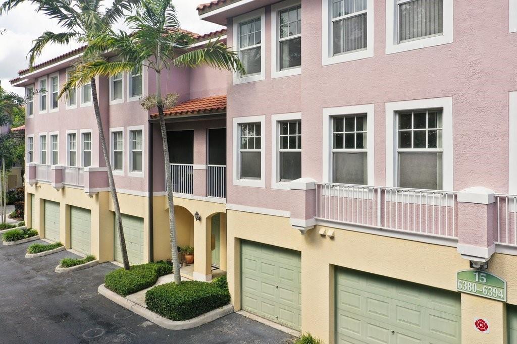 6384 West Sample Road, Unit 6384 Coral Springs, FL 33067 - Photo 6 of 8 a front view of a house with a yard