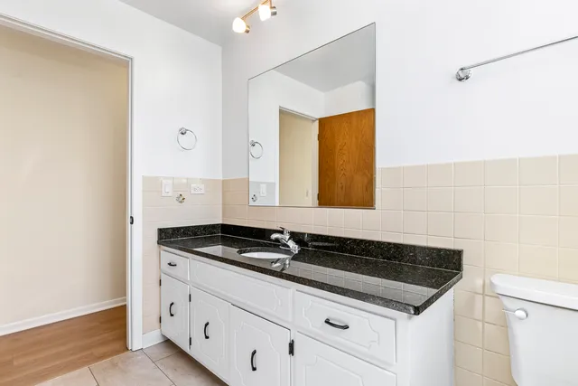 a close view of a sink a mirror and a vanity